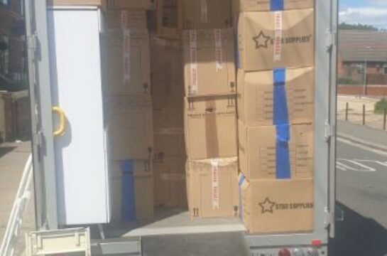inside the economy moves van it is filled with moving boxes.
